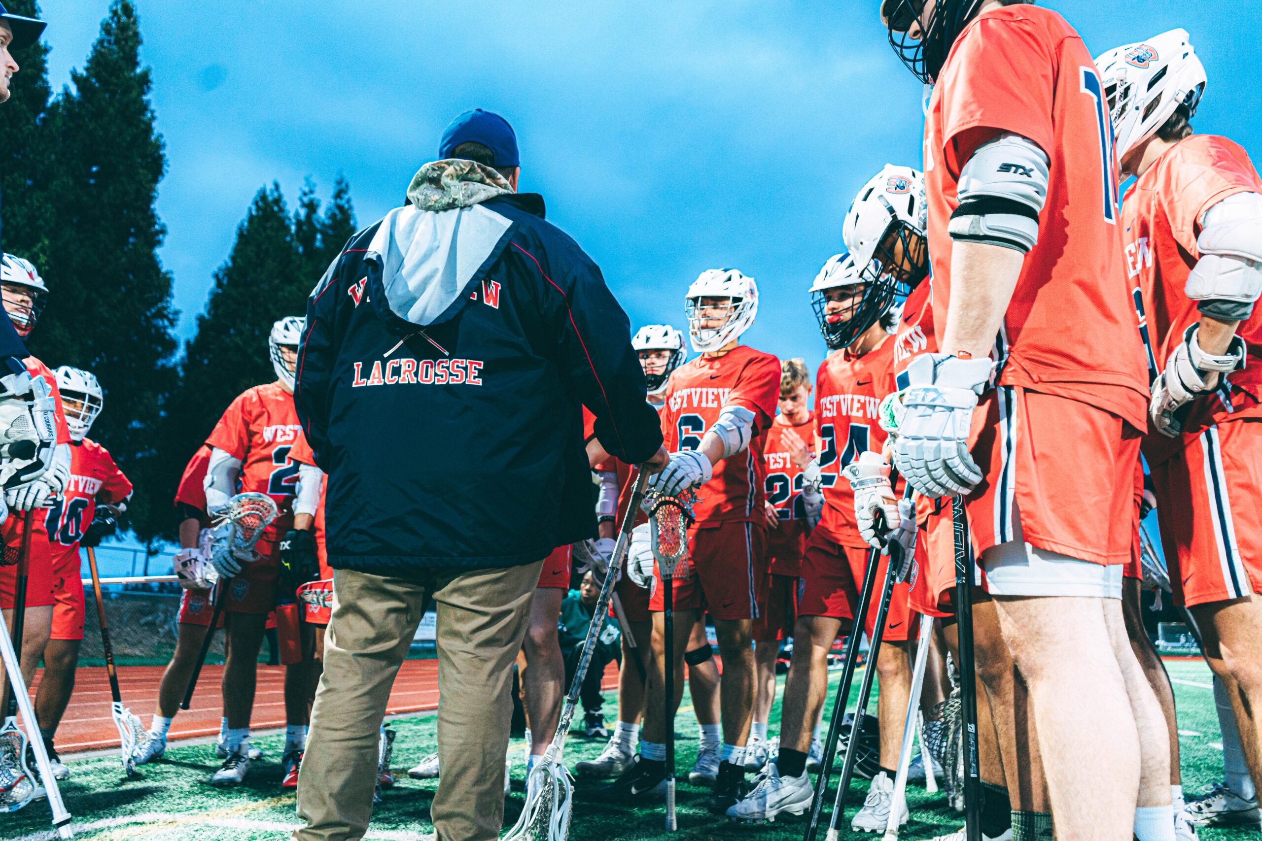 Mens lacrosse with coach